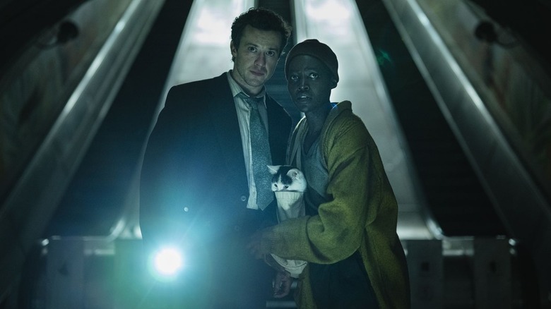Joseph Quinn and Lupita Nyong'o as Eric and Samira, using a flashlight in A Quiet Place: Day One