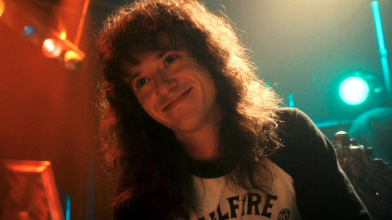Joseph Quinn as Eddie Munson, playing his guitar in Stranger Things