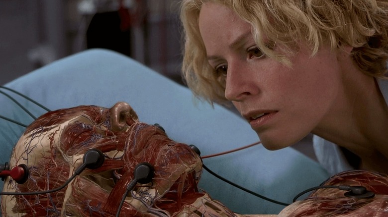 Linda peers over Caine's invisible form in Hollow Man