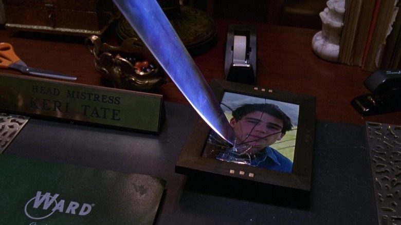 A knife stabbing a portrait of John in Halloween H20: 20 Years Later