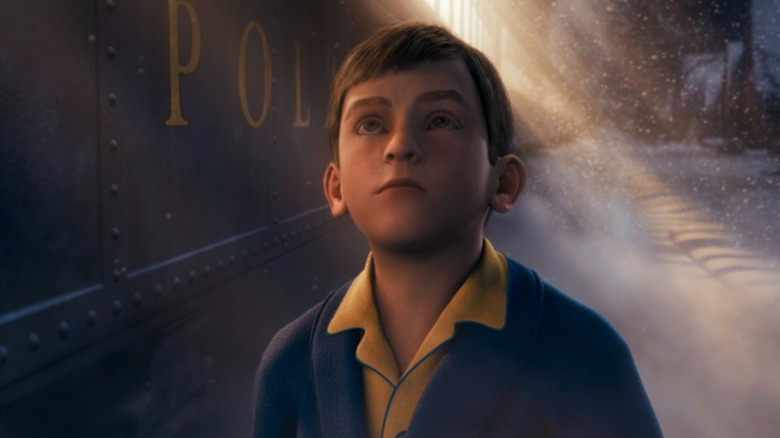 Hero Boy standing next to the Polar Express in The Polar Express