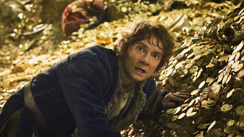Bilbo on a pile of gold in The Hobbit: The Desolation of Smaug