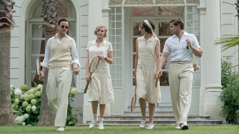 Harry Hadden-Paton, Laura Carmichael, Tuppence Middleton and Allen Leech walking together in Downton Abbey: A New Era