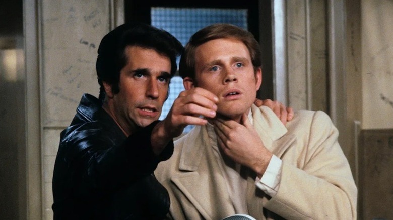 Henry Winkler as Fonzie dispenses bathroom wisdom to Ron Howard as Richie in Happy Days