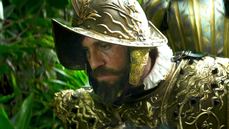 Édgar Ramírez as Aguirre wearing conquistador armor while kneeling in Jungle Cruise