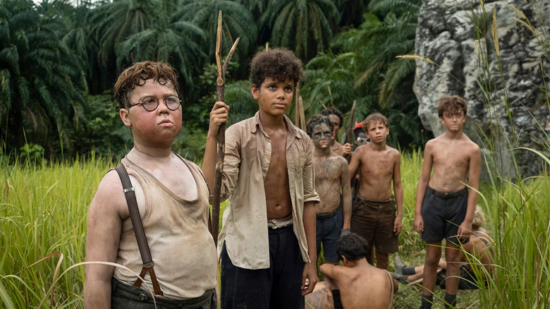 Piggy and several other boys in Lord of the Flies