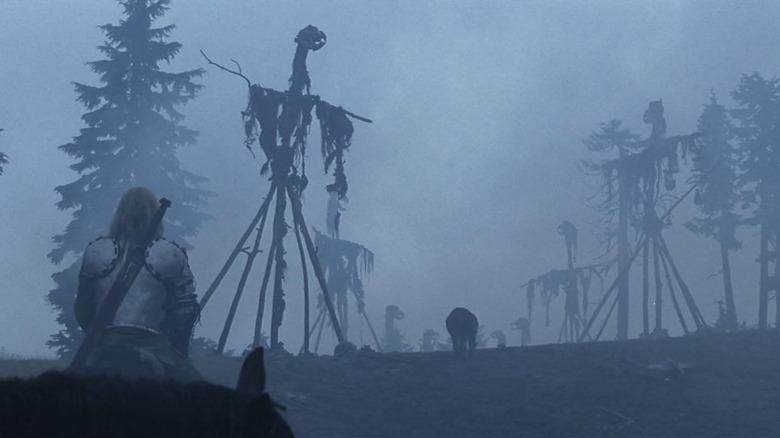 A viking riding toward terrifying figures in the fog in The 13th Warrior