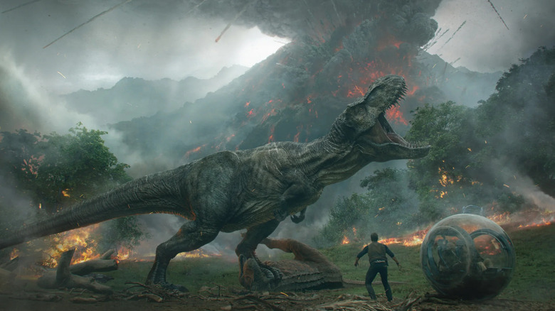 T-rex roars in front of Chris Pratt's Owen Grady as volcano erupts