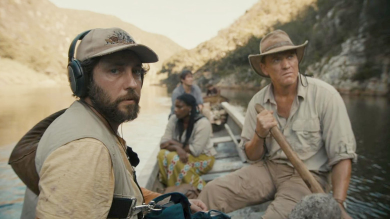 A filmmaking crew riding a boat in 