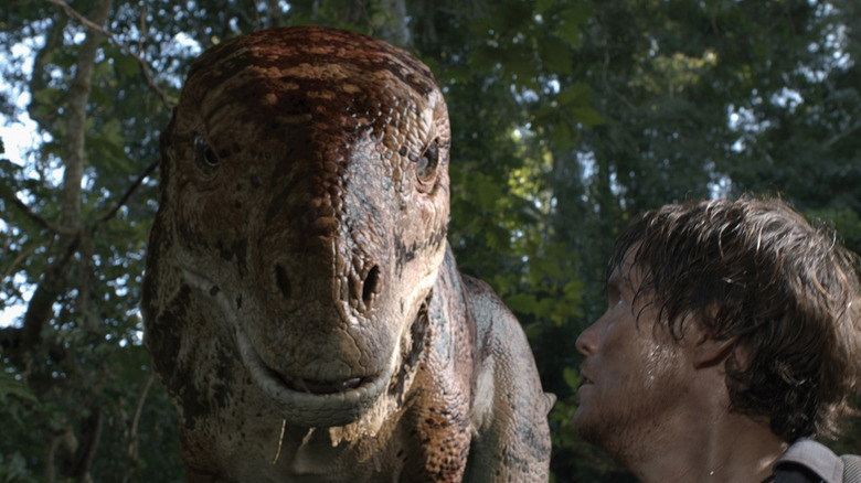Charlie (Peter Brooke) looking at a dinosaur in "The Dinosaur Project."