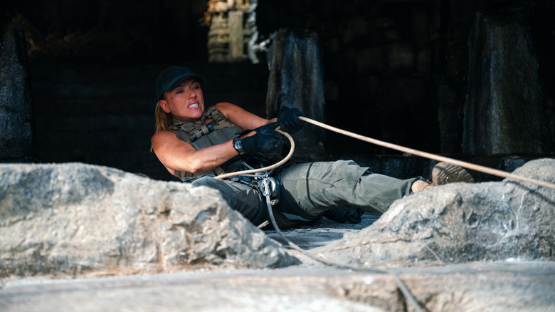 Scarlett Johansson as Zora Bennett desperately holding onto a climbing rope in Jurassic World Rebirth