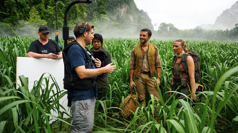 Gareth Edwards, Jonathan Bailey, and Scarlett Johansson on the grasslands set of Jurassic World Rebirth