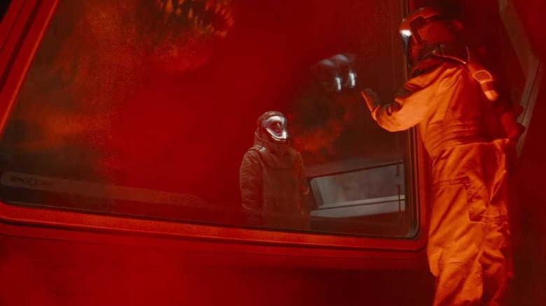 The D-rex attacks scientists bathed in red light in Jurassic World Rebirth