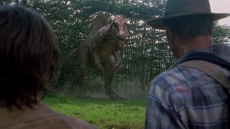 Dr. Grant and his associates stare at a Spinosaurus in Jurassic Park 3
