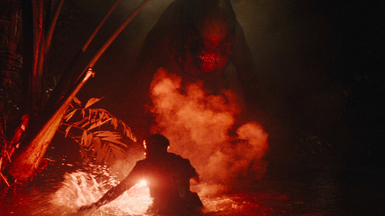 The D-rex coming towards Duncan while he lights up a flare in Jurassic World Rebirth