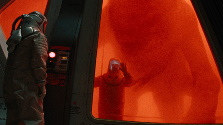 A laboratory worker trapped in a cage with D-Rex in the birth of the Global Jorani