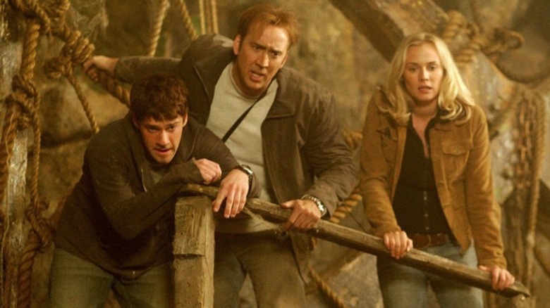 Treasure hunters look over ledge