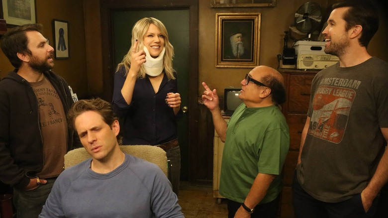 Dee in a neck brace surrounded by Charlie Frank Mac and Dennis on It's Always Sunny in Philadelphia