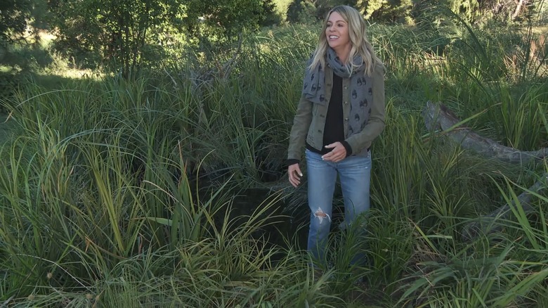 Dee walking near a bog and smiling in