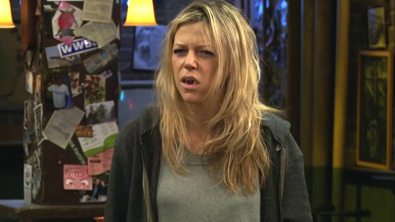Kaitlin Olson in the role of Dee eats a garbage cake and looks terrible