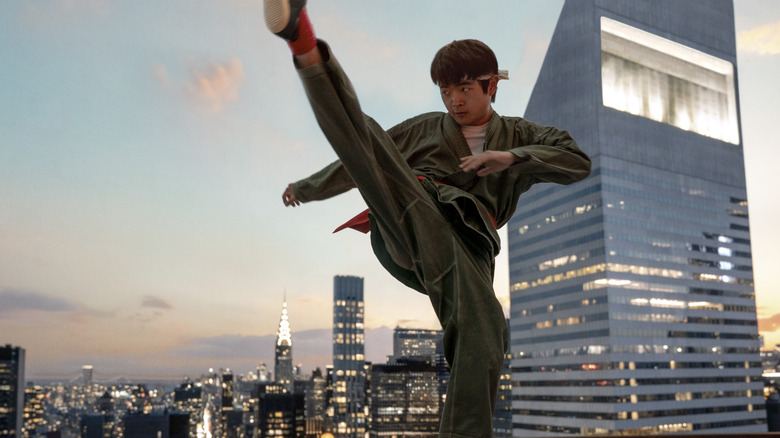 Ben Wang as Li Fong kicks on the roof in Karate Kid: Legends
