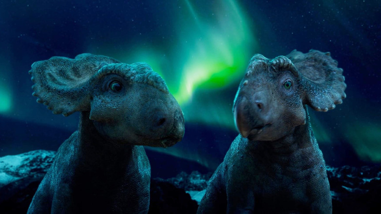 Justin Long as Patchi and Tiya Sircar as Juniper standing together at night in Walking with Dinosaurs (2013)
