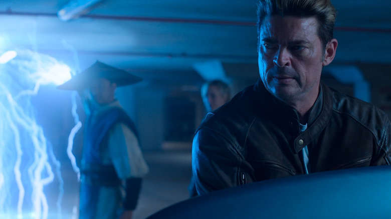 Karl Urban as Johnny Cage looking back at Tadanobu Asano as Raiden and Jessica McNamee as Sonya in Mortal Kombat II