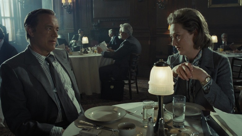 Tom Hanks as Ben Bradlee and Meryl Streep as Katharine Graham sitting at a table in The Post