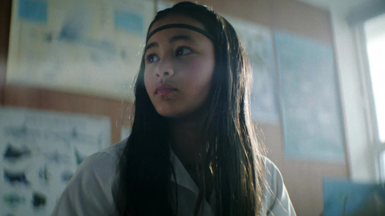 Kaylee Hottle as Jia sitting in a classroom in Godzilla x Kong: The New Empire