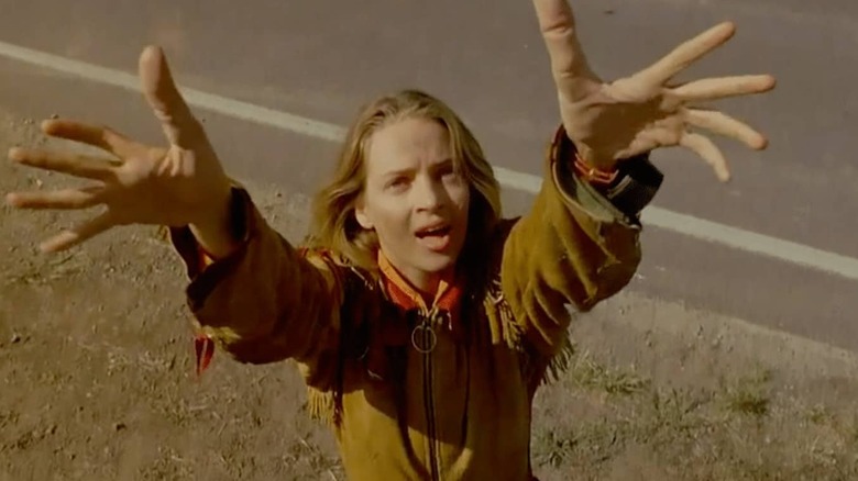 Sissy Hankshaw holding up her enhanced hands in Even Cowgirls Get the Blues