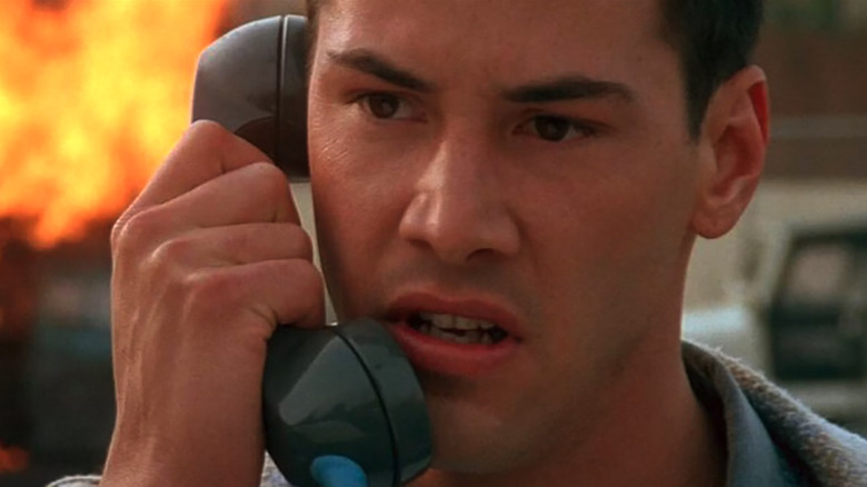 Speed, Keanu Reeves' Jack on the phone after an explosion
