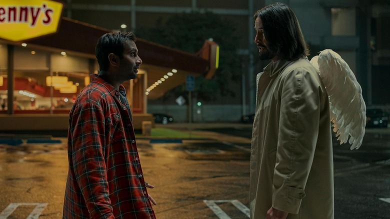 Aziz Ansari as Arj standing opposite Keanu Reeves as Gabriel next to a Denny's in Good Fortune