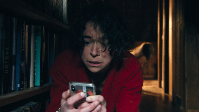 Liz isn't getting a signal while a creature lurks behind her in Keeper