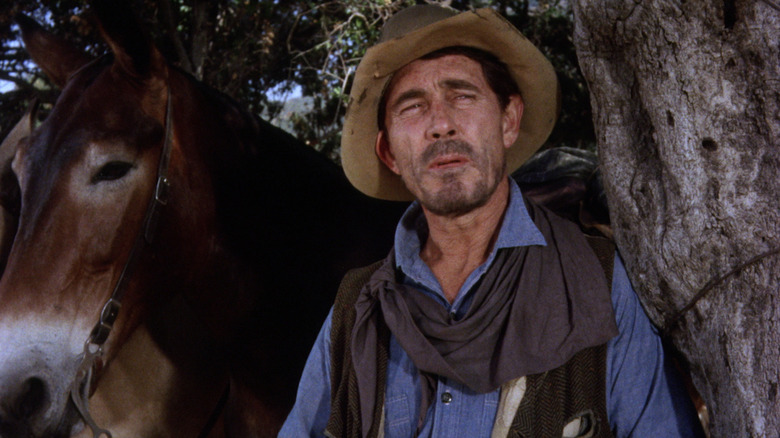 Festus Haggen standing next to his horse in Gunsmoke
