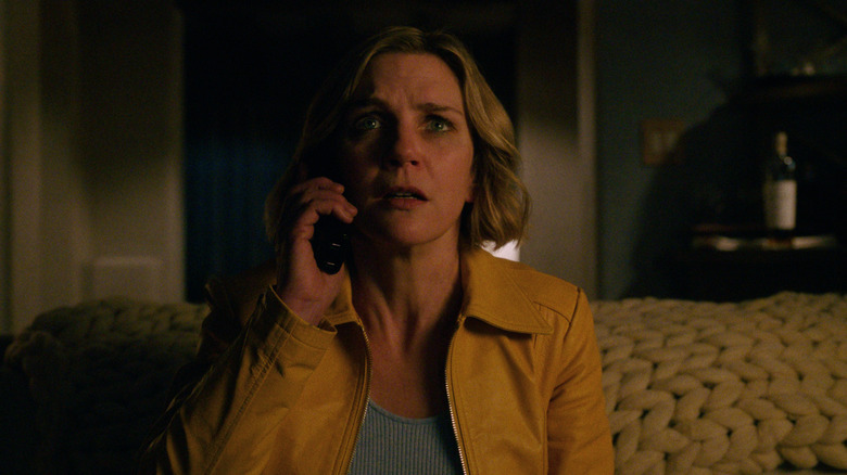 Rhea Seehorn's Carol Sturka looking aghast and speaking on the phone on Pluribus