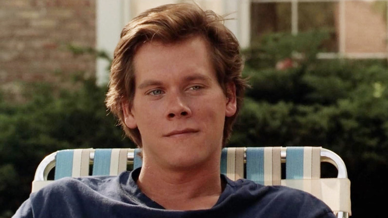 Kevin Bacon as Jake Briggs sitting in a lawn chair in She's Having a Baby