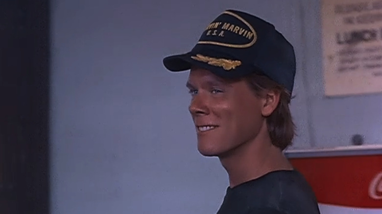 Kevin Bacon's Everett Holly smiles as he walks across a room in End of the Line