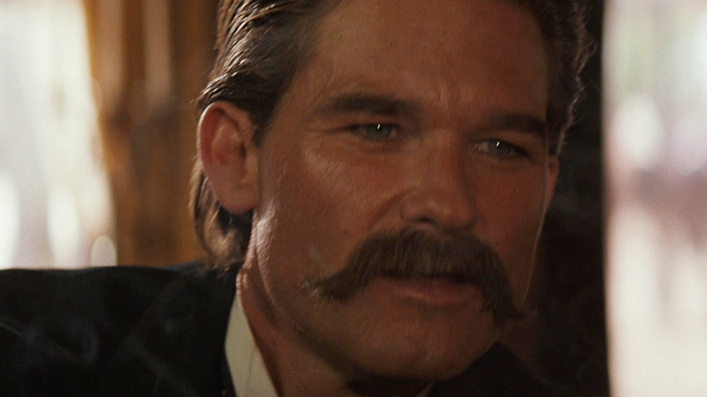 Kurt Russell as Wyatt Earp looking worried in Tombstone