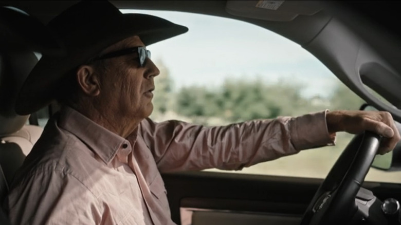 Kevin Costner's John Dutton drives a car in Yellowstone