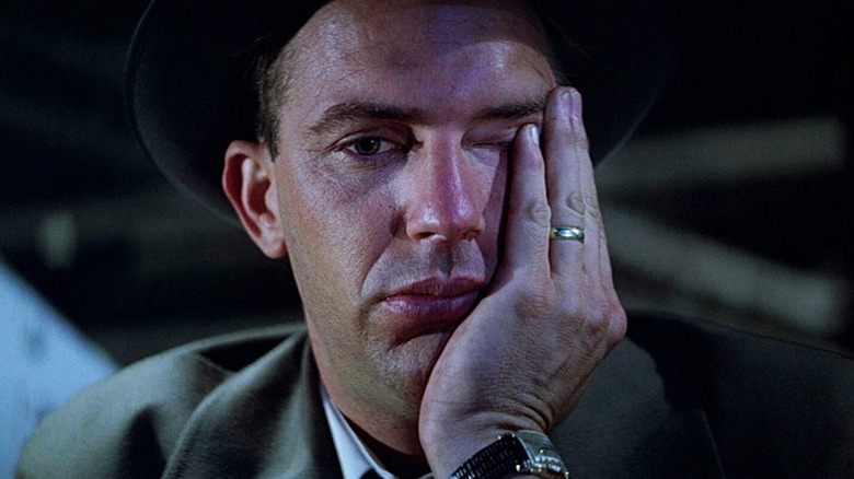 Kevin Costner rubs his face as defeated Eliot Ness in The Untouchables