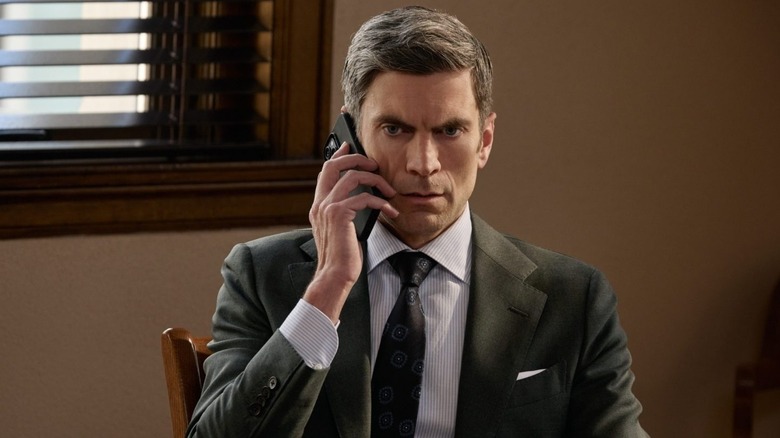 Wes Bentley as Jamie Dutton seated in a chair and taking a phone call in Yellowstone