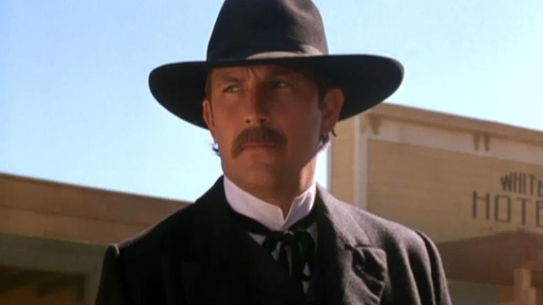 Wyatt Earp standing in front of a hotel in 