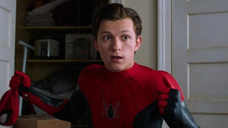 kid in spiderman suit without mask looking shocked