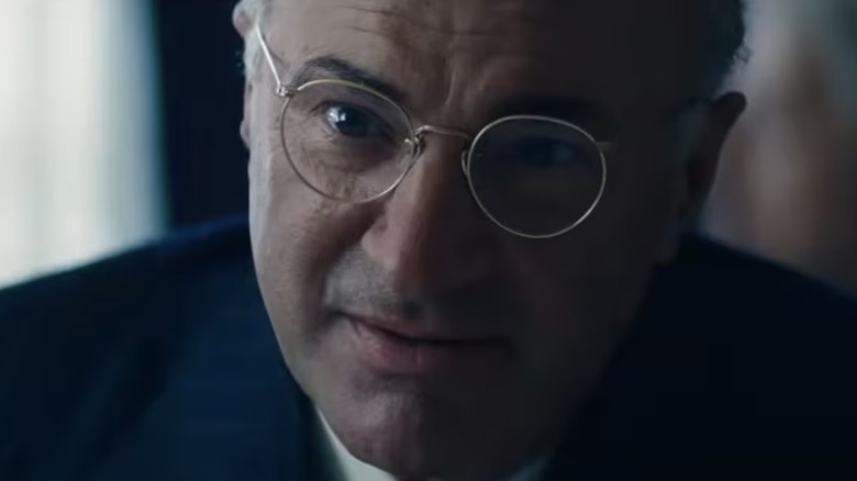 Milton Rockwell leaning close in Marty Supreme