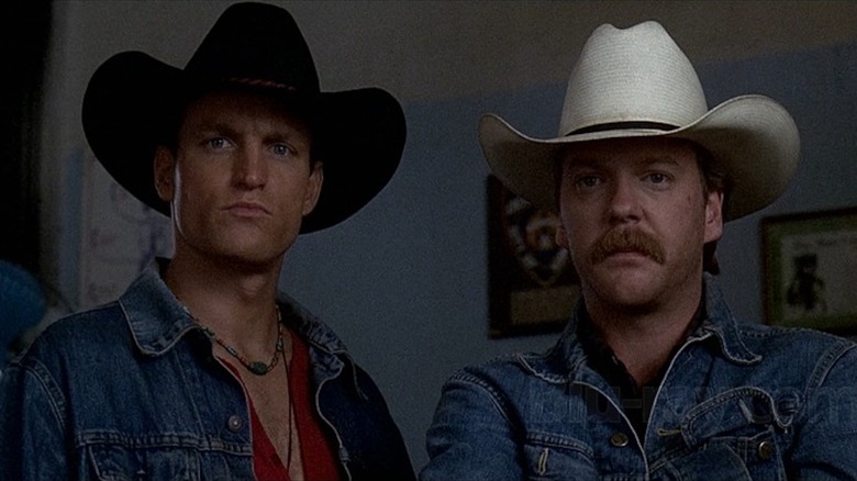 Woody Harrelson as Pepper Lewis and Kiefer Sutherland as Sonny Gilstrap look dead serious in cowboy hats in The Cowboy Way