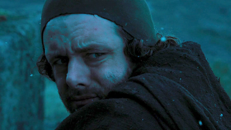 Michael Sheen as the Priest looks over his shoulder in Kingdom of Heaven