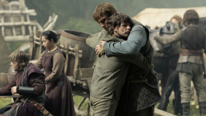 Peter Claffey as Dunk and Shaun Thomas as Raymun hugging each other farewell in A Knight of the Seven Kingdoms
