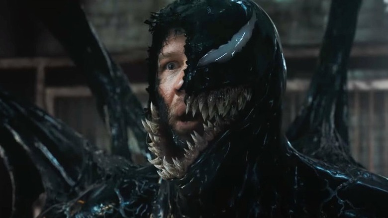 Venom with half his face open to reveal Eddie inside him in Venom: The Last Dance
