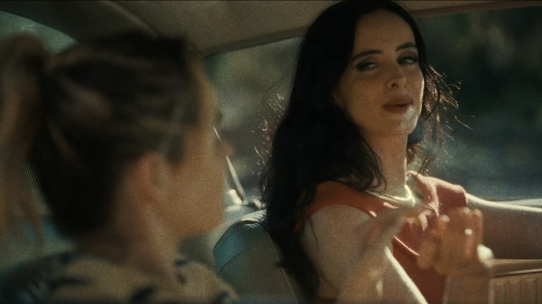 Krysten Ritter's Goldie looks across at Kiernan Shipka's Fox as they sit in a car in Stone Cold Fox