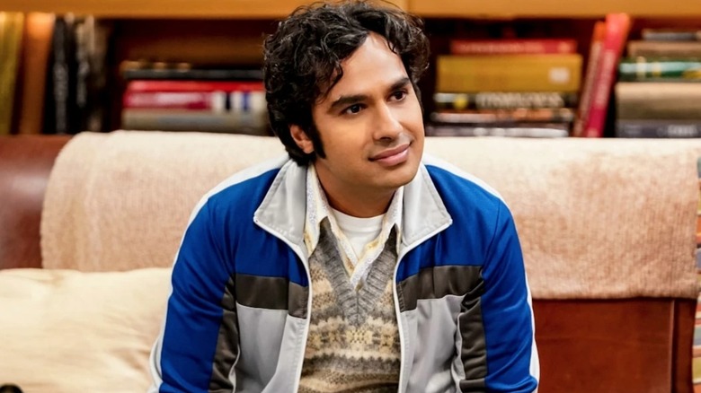 Raj sitting on the couch with curly hair on The Big Bang Theory